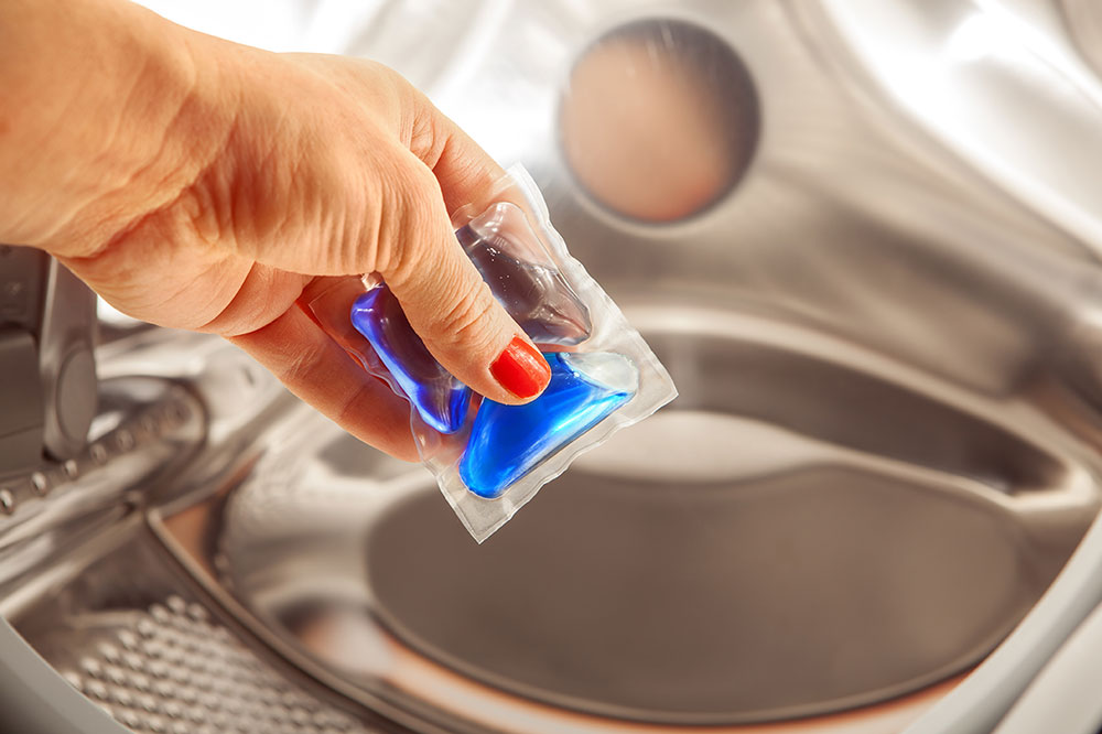 Woman holding a detergent pod