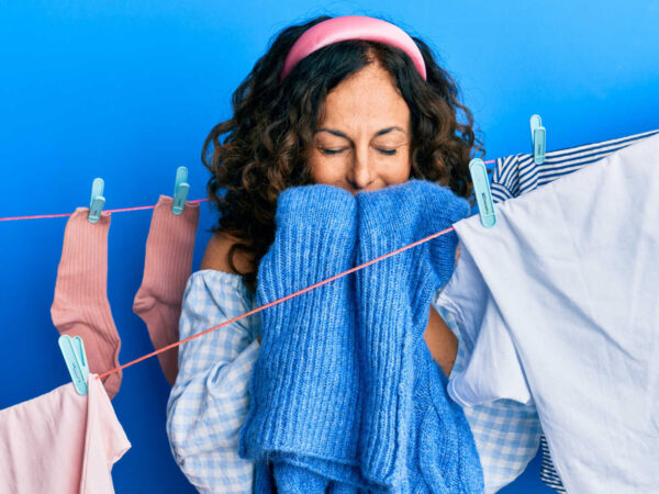 Fresh-smelling clothes – Woman smelling clean washing