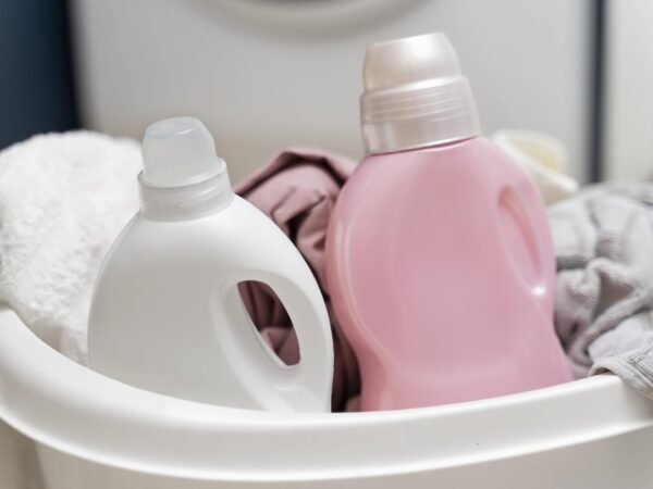 liquid detergent in laundry basket with laundry clothes