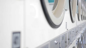 Image Alt Text Wash clothes in hot or cold water – Close up of laundromat machines