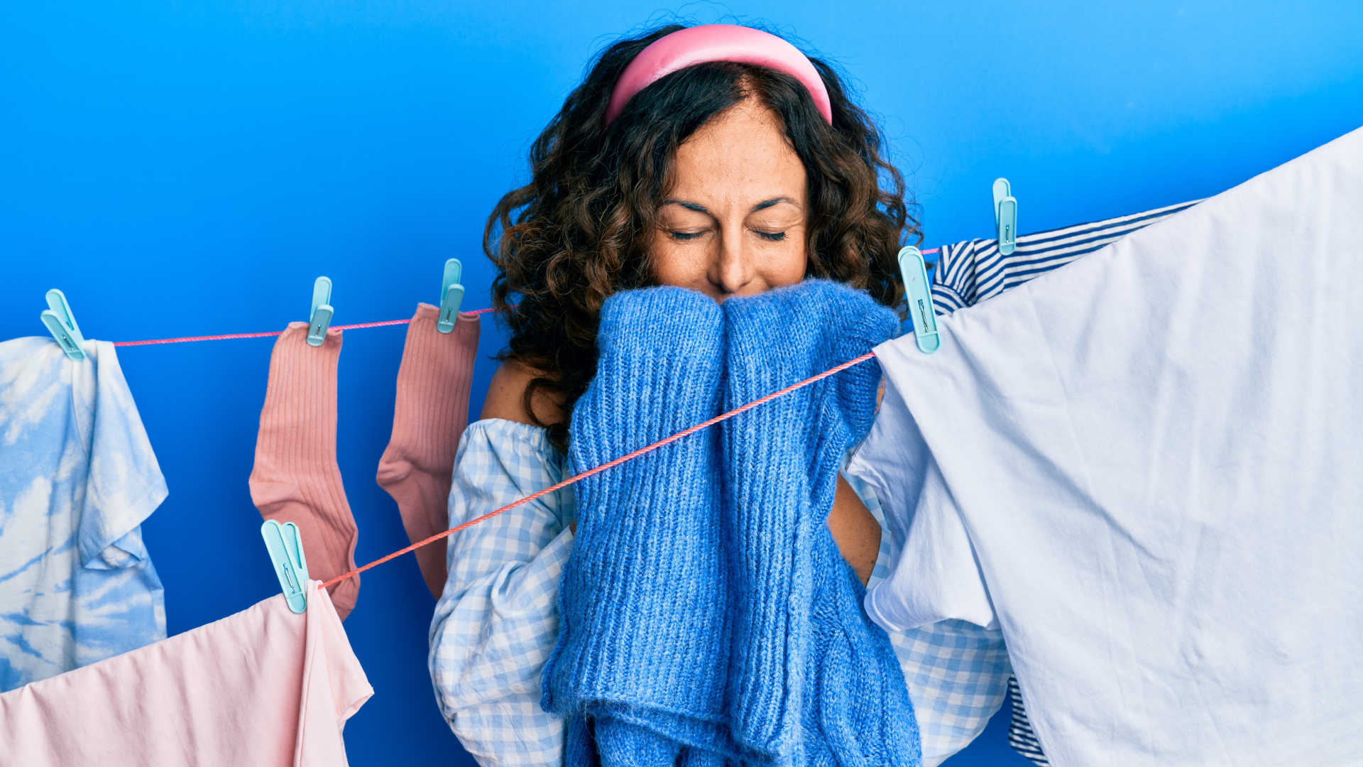 Fresh-smelling clothes – Woman smelling clean washing