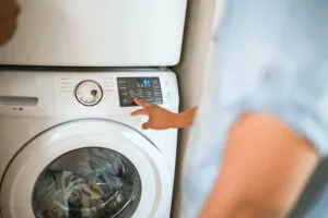 Man setting up washing machine for cleaning clothes