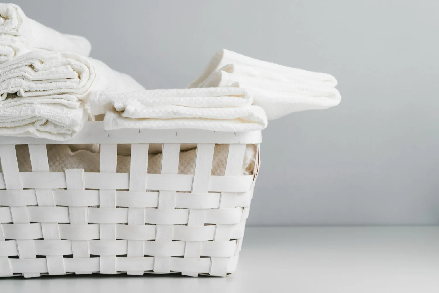 white basket with fresh clean clothes