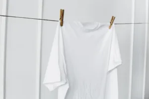 White shirt hanging by wall scaled