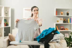 Woman happy holding clean clothes ready for folding